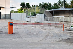 Automatic barrier, entry into the territory, blocking the way, orange red barrier, metal fence