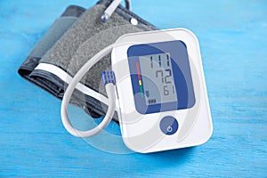 Automatic blood pressure meter on blue background