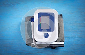 Automatic blood pressure meter on blue background