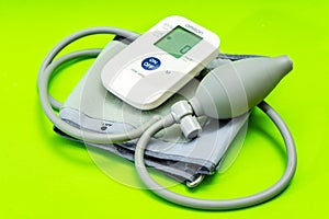 Automatic blood pressure monitor or blood pressure meter on green background. Medical equipment