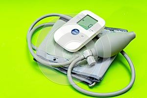 Automatic blood pressure monitor or blood pressure meter on green background. Medical equipment