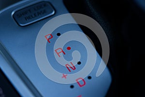 Automatic Car gear position control panel and the gear lever at reverse position.