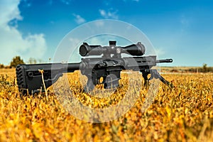 Automatic carbine with a telescopic sight. A sniper weapon mounted on a bipod. Gun for long-range aimed shooting photo