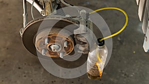 Automatic change of brake fluid in a car service.
