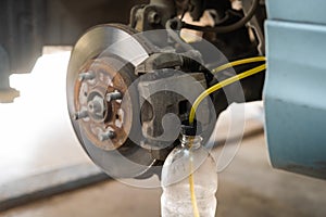 Automatic change of brake fluid in a car service.