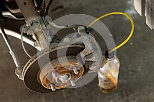 Automatic change of brake fluid in a car service.