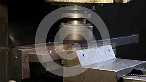 Automatic cnc turning milling machine cutting metal workpiece with sparks at factory. The metalworking process.  Metalworking and