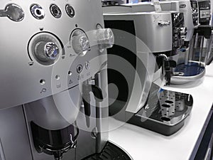 Automatic coffee machines at exhibition on white kitchen background