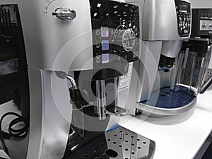Automatic coffee machines at exhibition on white kitchen background