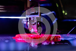 Automatic 3D printer machine printing flat plastic model: close up