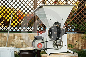 Automatic destemmer crusher machine. Small business concept. Wine Making process. Homemade wine