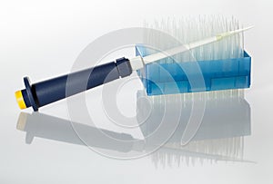 Automatic dropper and tips pack on white reflective plane