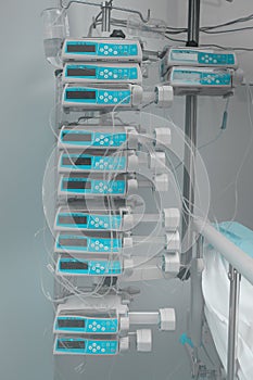 Automatic drug perfusion devices in stack at the hospital room`s photo