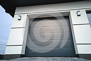 Automatic electric roll-up commercial garage gate or push-up door in modern private building ground floor