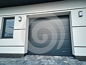 Automatic electric roll-up commercial garage gate or push-up door in modern private building ground floor