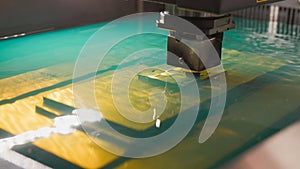 Automatic factory - cutting of sheet metal process in water, front view