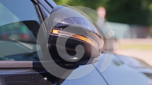 Automatic folding of the side mirror of a modern car. blinking of the turn signal on rearview mirror