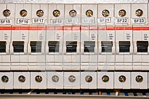 Automatic fuse electrical connector in power lines located inside of switch control panel board. Industrial background.