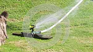 Automatic garden lawn sprinkler watering green grass