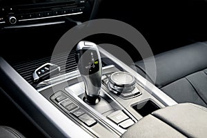 automatic gear stick of a modern car, car interior details.