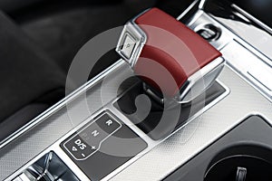 Automatic gear stick of a modern car. Modern car interior details. Close up view. Car inside. Automatic transmission lever shift.