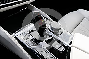 Automatic gear stick of a modern car. Modern car interior details. Close up view. Car detailing. Automatic transmission lever shif