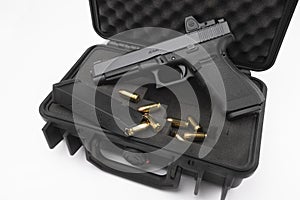 Automatic gun and bullets in a plastic hard case on white background