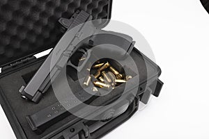 Automatic gun and bullets in a plastic hard case on white background