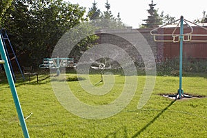Automatic lawn sprinkler watering green grass. Sprinkler with automatic system. Garden irrigation system watering lawn