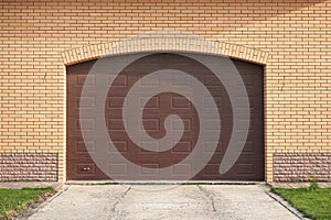 Automatic lifting garage door on bricks wall