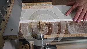 Automatic machine tool makes holes in wooden details of furniture. Furniture production, a machine makes a hole, close