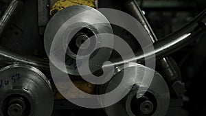 Automatic metalworking machine for bending industrial steel tubes. Creative. Close up of working machine at a factory.