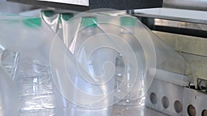 Automatic packaging of plastic bottles with film in the temperature press. Packaging of bottles for further