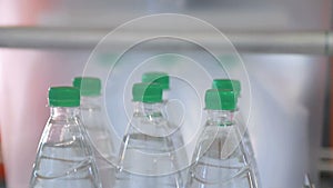 Automatic packaging of plastic bottles with film in the temperature press. Packaging of bottles for further