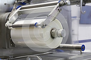 Automatic packing machine. Packing in a transparent cellophane film