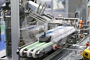 Automatic packing machine with plastic bag and paper box