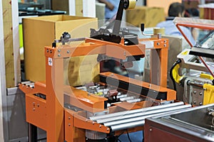 Automatic packing machine with plastic bag and paper box