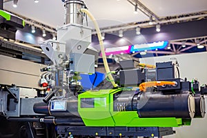 Automatic plastic injection molding machine during work at exhibition