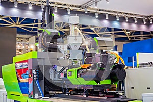 Automatic plastic injection molding machine during work at exhibition