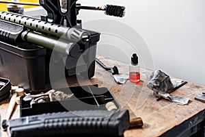 Automatic rifle on stand on the table of the weapons workshop.