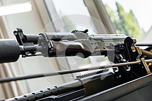 Automatic rifle on stand on the table of the weapons workshop.
