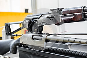 Automatic rifle on stand on the table of the weapons workshop.