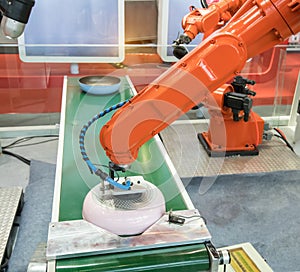 Automatic robot in assembly line working in factory