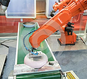 Automatic robot in assembly line working in factory photo