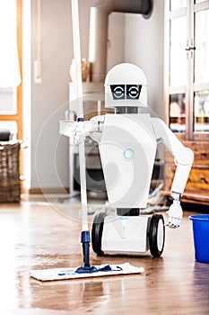 Automatic robot floor scrubber is doing his work