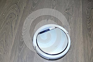 Automatic robot vacuum cleaner is white during operation. Cleans the floor. movement from the bottom up