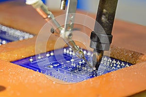 The automatic soldering machine operation with PCB board