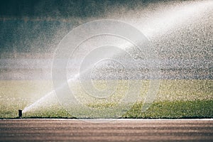 Automatic sprinklers watering grass