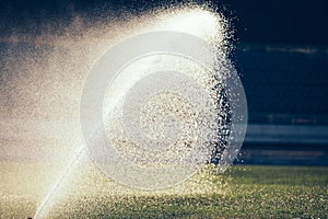 Automatic sprinklers watering grass