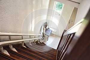 Automatic stairlift on staircase for elderly or disability in a house,